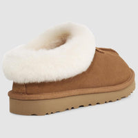 Brown slipper with white fur lining on a light gray background