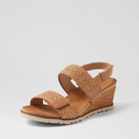 Ziera Kift wedge sandal in coffee-toned raffia with adjustable straps, cushioned footbed, and mid-height wedge sole on a white background
