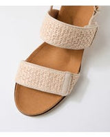 Ziera Kift wedge sandal in natural-toned raffia with adjustable straps, cushioned footbed, and mid-height wedge sole on a white background