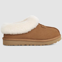 Brown slipper with white fur lining on a light gray background