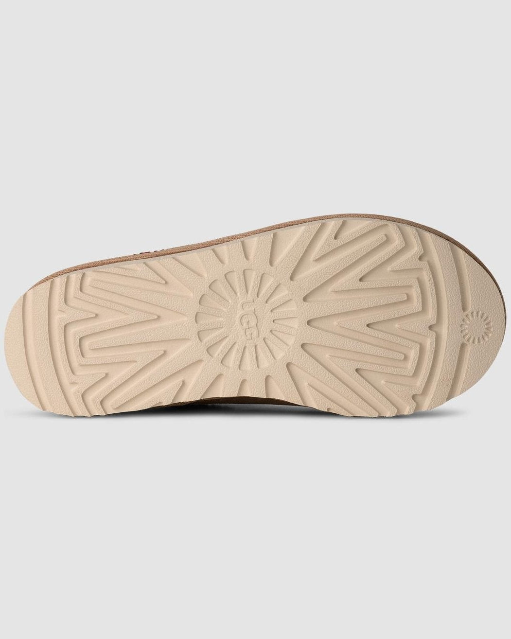 Close-up of a beige shoe sole on a light gray background