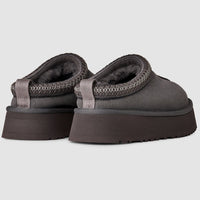 Pair of gray platform sandals on a light gray background