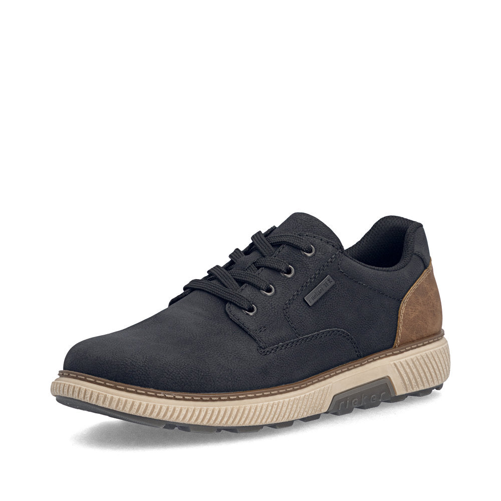 A single low-top casual sneaker shown from a three-quarters angle on a white background. The shoe features a dark navy blue suede upper, black laces, a brown heel accent, and a thick beige midsole with a dark gray outsole.