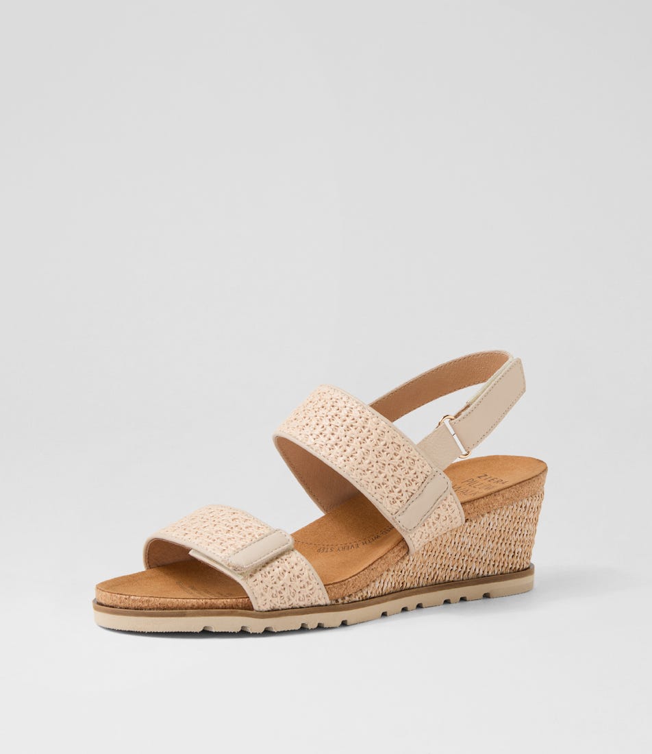Ziera Kift wedge sandal in natural-toned raffia with adjustable straps, cushioned footbed, and mid-height wedge sole on a white background
